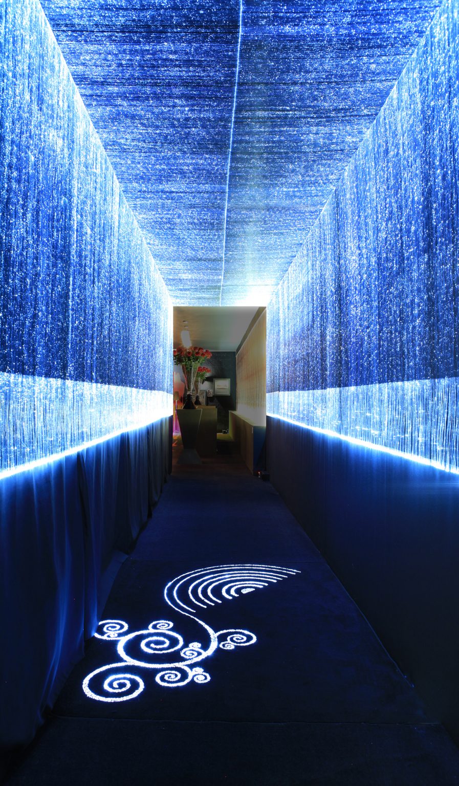 Blue illuminated fiber-optic curtain corridor